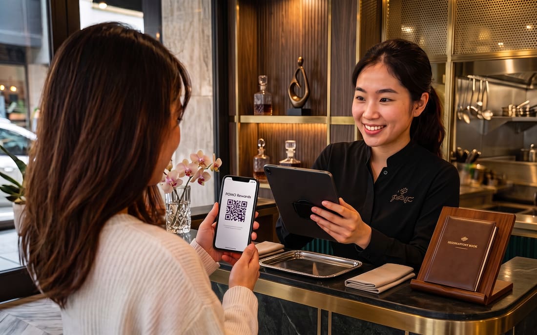 A student showing their QR pass to staff to be scanned at the counter